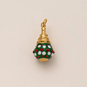 Detail of vintage 18K gold plated snowflake enamel pendant with red and white polka dots