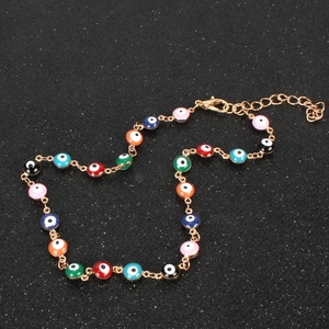 Colorful Evil Eye necklace in gold alloy featuring vibrant enamel beads on a black background