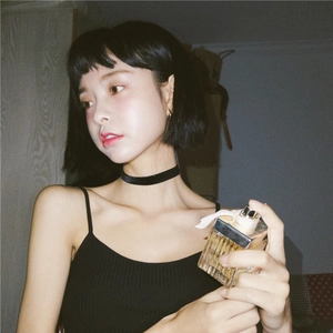 Close-up of minimalist black velvet choker necklace on model's neck for a vintage look