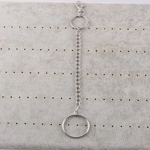 Silver punk style metal waist chain with lobster clasp and round rings on grey background
