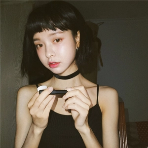 Minimalist black velvet choker necklace shown on model for a trendy punk fashion look
