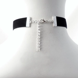 Minimalist black velvet choker necklace with silver lobster clasp shown on model neck