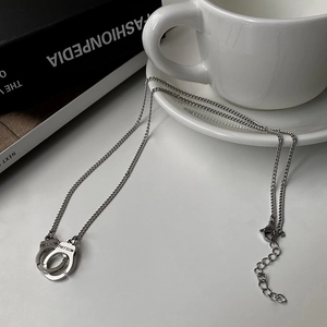 Detailed shot of silver handcuffs pendant with Freedom engraving on fashion chain