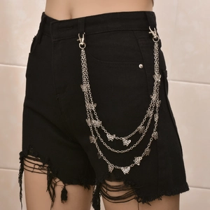 Detail showing triple-layered silver metal butterfly chain on black denim shorts