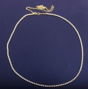 Close-up of gold tennis chain link with micro-pave zircons and adjustable lobster clasp