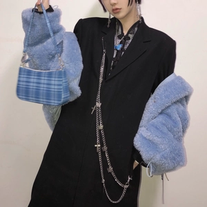 Stylish blue and white checkered baguette armpit bag styled on a blue fuzzy jacket