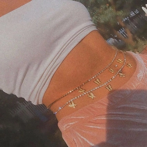 Sexy double-layered gold waist chain with butterfly pendants and zircon accents on a model