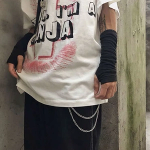 Close-up of hip-hop street style white t-shirt featuring I'M A NINJA print and metal chains