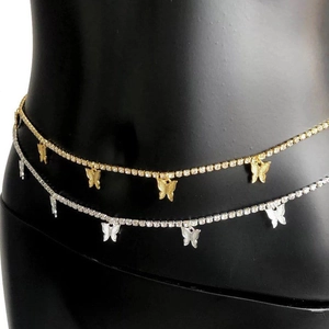 Detailed close-up of gold and silver butterfly waist chains with zircon on a mannequin