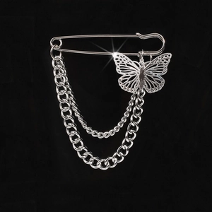 Detail of silver butterfly pin featuring double-layer chains and hollow metal pendant