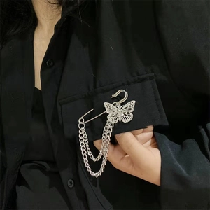 Silver double-layer chain butterfly brooch pinned on black shirt pocket for hip-hop style