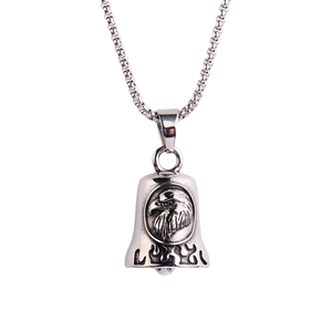 Detailed view of silver stainless steel bell pendant with eagle head and flame engraving