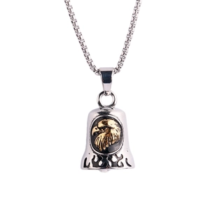 Detail of silver eagle bell pendant with gold eagle relief and black flame patterns