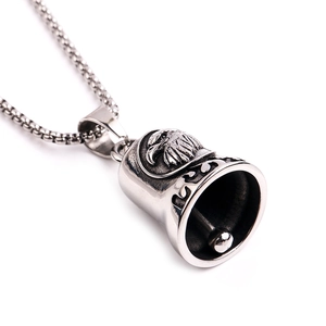 Macro shot of retro silver eagle relief bell pendant made of durable stainless steel