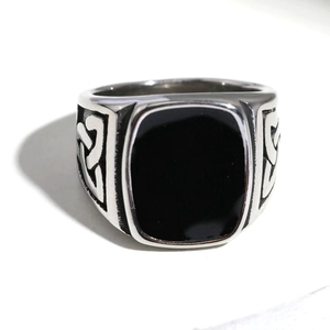 Vista macro di anello vichingo in acciaio inossidabile con intarsio nero e nodi celtici
