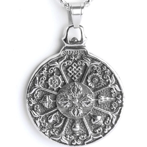 Macro view of vintage stainless steel pendant with Buddhist symbols and vajra engraving