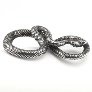 Detailed macro view of the realistic snake scale texture on punk stainless steel pendant