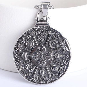 Macro shot of Buddhist Eight Auspicious Symbols on a round stainless steel pendant