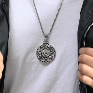 Close-up of a men's vintage silver Buddhist amulet pendant with box chain on model