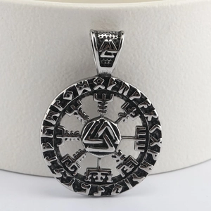 Macro detail of vintage Viking Vegvisir and Valknut pendant in stainless steel