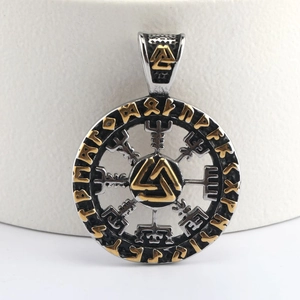 Close-up of a silver and gold punk Viking totem pendant with Vegvisir runes