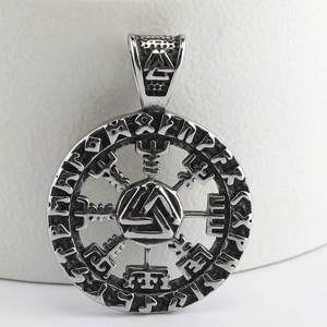 Macro detail of Nordic Viking Valknut pendant with engraved Runic alphabet symbols