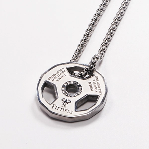 Detailed close-up of barbell weight plate pendant with motivational fitness engraving