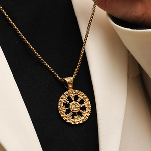 Macro shot of gold Valknut and Vegvisir Norse runes engraved on a round pendant necklace