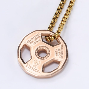 Macro view of rose gold dumbbell pendant necklace with inspirational fitness engraving