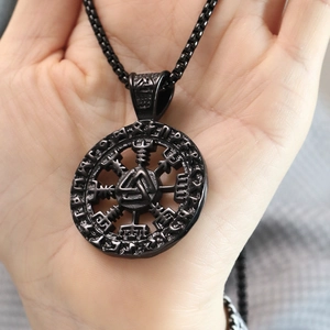 Detailed view of black Viking Valknut pendant with runic alphabet and Vegvisir compass