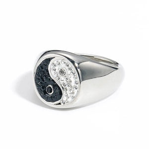 Macro detail of silver titanium ring featuring black and white crystal Yin Yang pattern