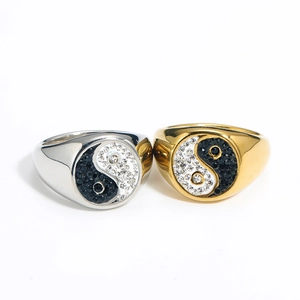 Detail view of gold and silver yin yang rings with black and white pavé rhinestones