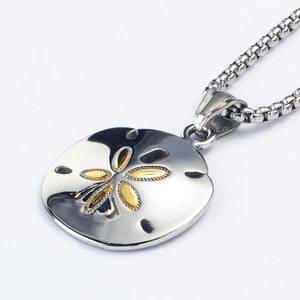 Macro shot of a silver sand dollar pendant with a golden sunburst on a round box chain