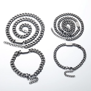 Detail of four-piece vintage gunmetal Cuban chain jewelry set with blank engraving plates