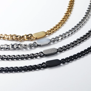 Detail of four multi-color Cuban link necklaces with engravable metal plaques