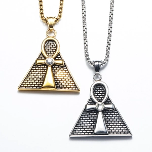 Detailed view of gold and silver Egyptian pyramid pendants with Ankh cross symbols