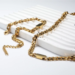Close-up of gold Cuban link chain set showing texture and rectangular metal clasps