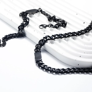 Macro shot of matte black cuban link necklace with custom metal plate and lobster clasp