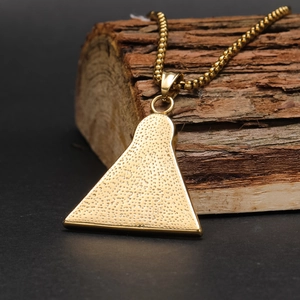 Hip hop ancient Egyptian eye of Horus pyramid gold pendant necklace on a wooden base