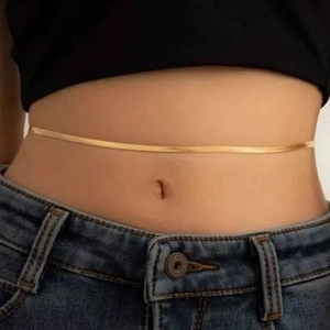 Minimalist 18K gold snake chain belly chain for women shown on waist with denim jeans