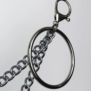 Detail of silver punk pant chain featuring a large metal ring and lobster clasp