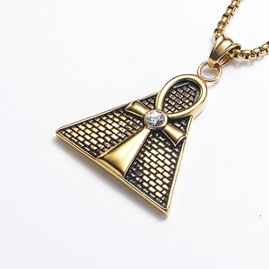 Detail of gold pyramid pendant with Egyptian Ankh cross and central crystal stone