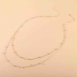 Elegant gold double-layered waist chain with round beads and zircon fringe pendants