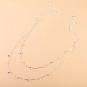Double-layered silver beaded waist chain featuring zircon tassel pendants for women
