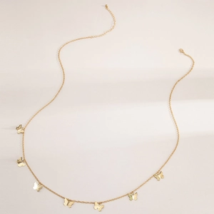 Close-up of golden metal waist chain featuring elegant butterfly pendants on a white background