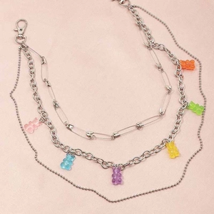 Detail of multi-layer silver pants chain with colorful resin bears and pin style links