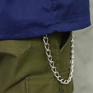 Silver metal pants chain with flat circular links on olive cargo pants for men