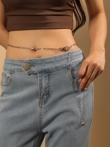 Detailed view of silver alloy waist chain with round disc pendant and lobster clasp