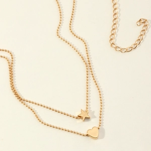 Golden double-layer body chain with star and heart pendants on beaded necklaces