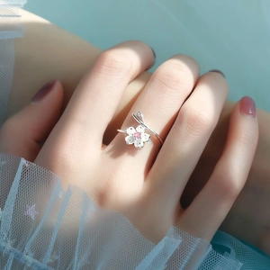 Pink zircon cherry blossom open ring in sterling silver on woman's hand